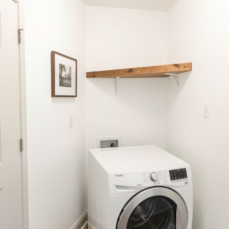 Budget laundry room makeover Simple decorated laundry room with white paint and shelf